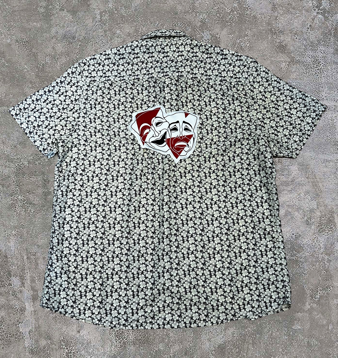 3D drama masks on the back of a yellow shirt, created by BRICK + BONE