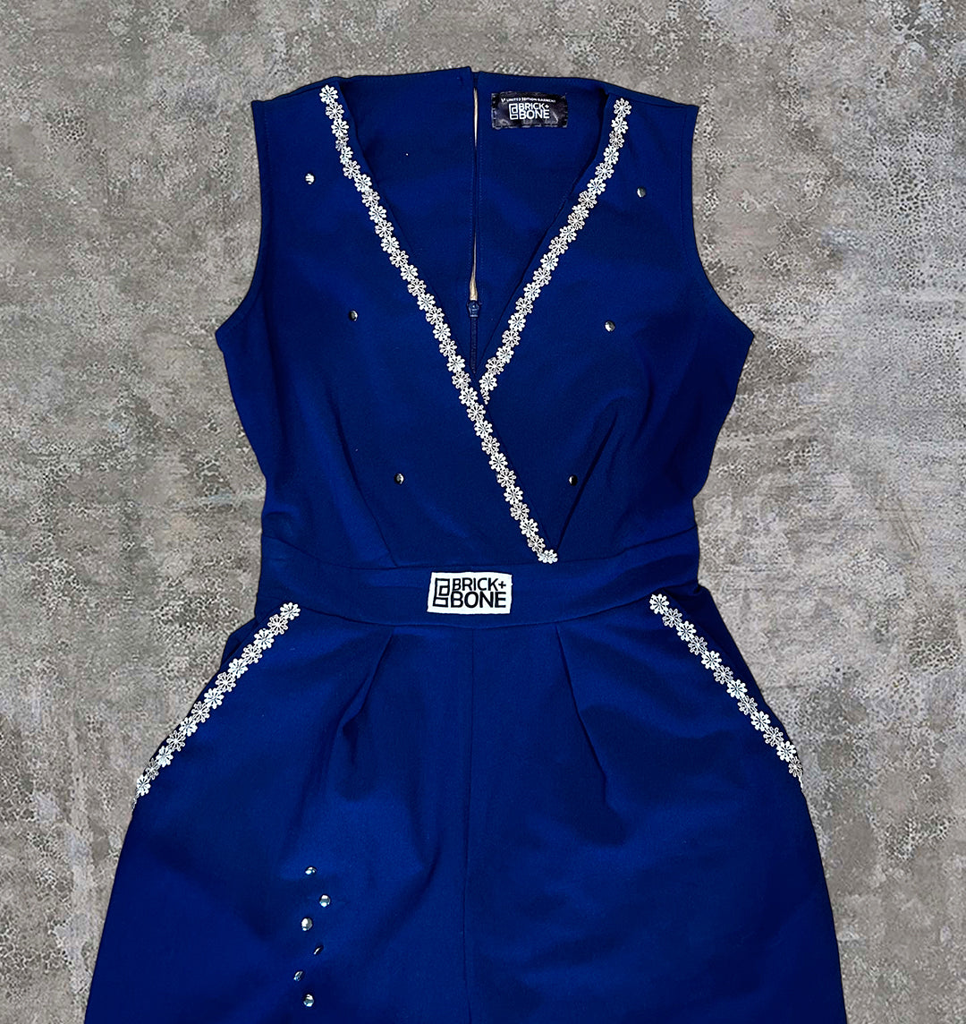 Lace trim on the blue jumpsuit, with soft velvet BRICK + BONE logo on the front