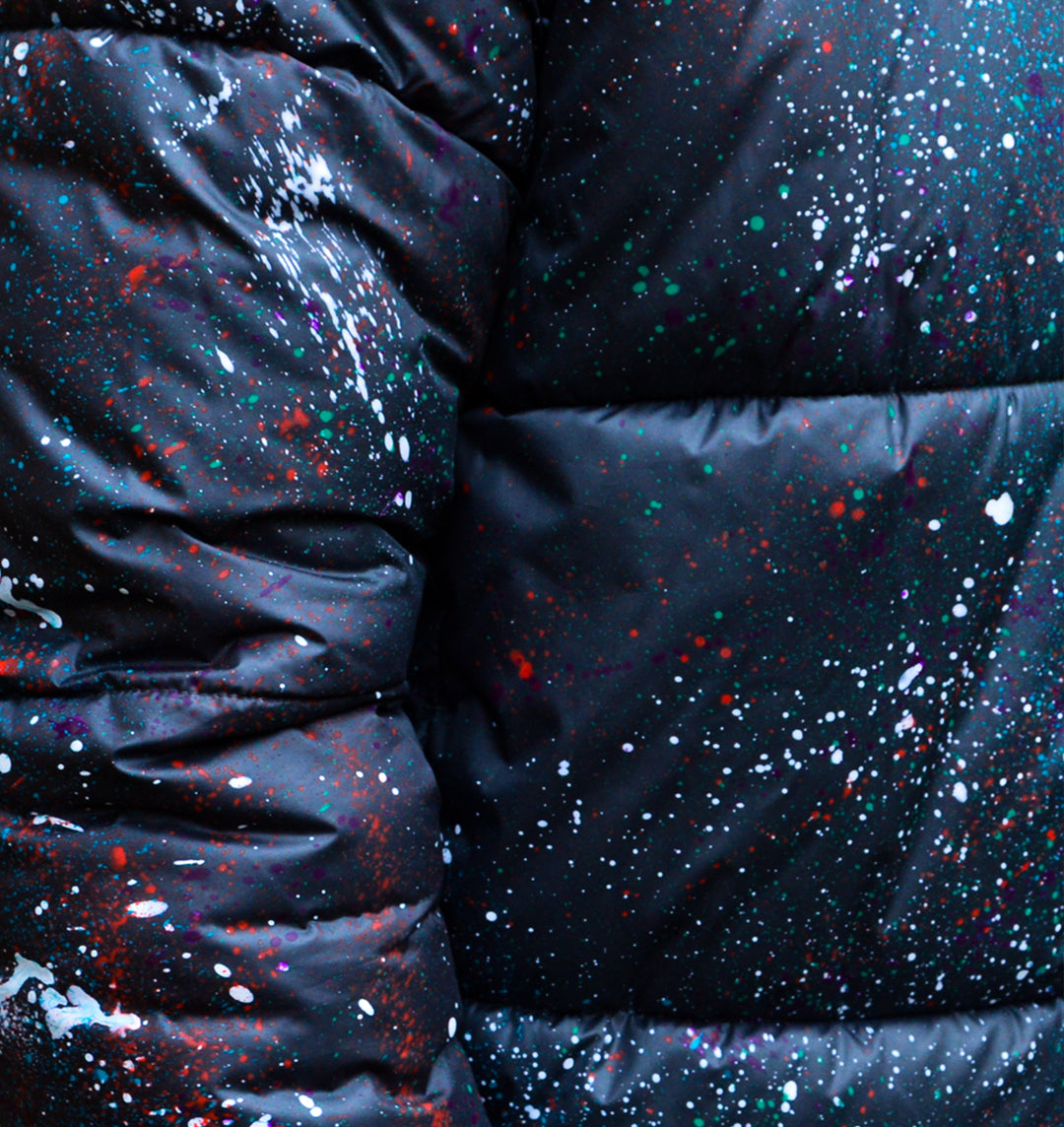 Close up of paint splatter detail across the puffer jacket