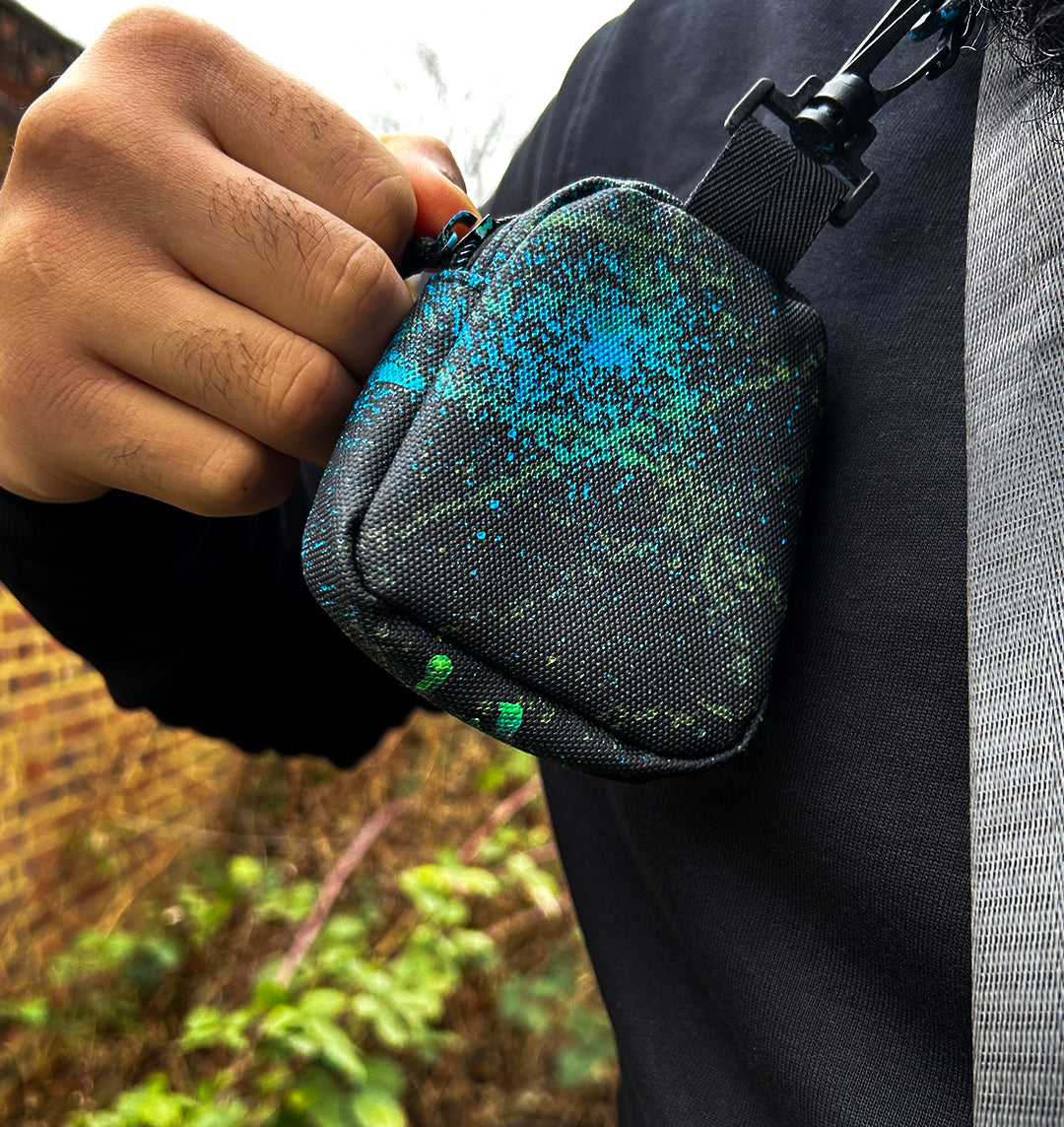 Small pouch attached to the crossbody bag, paint splattered in blue and green