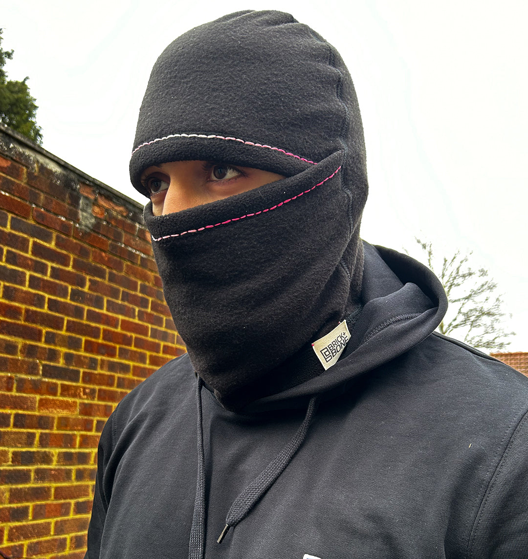 Hand stitched balaclava with pink contrast, two-tone stitching accenting the eyes