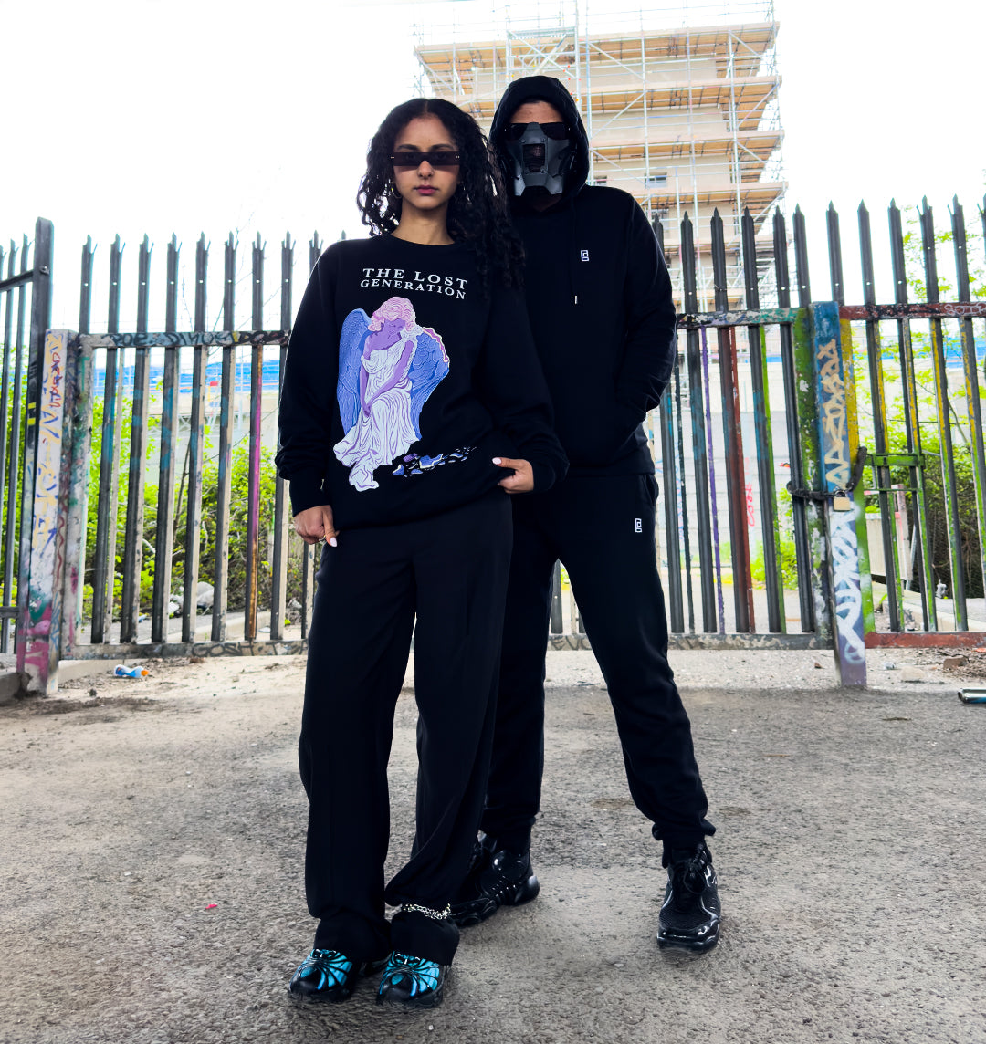 Man and woman wearing brick and bone clothing in gritty underground space in London